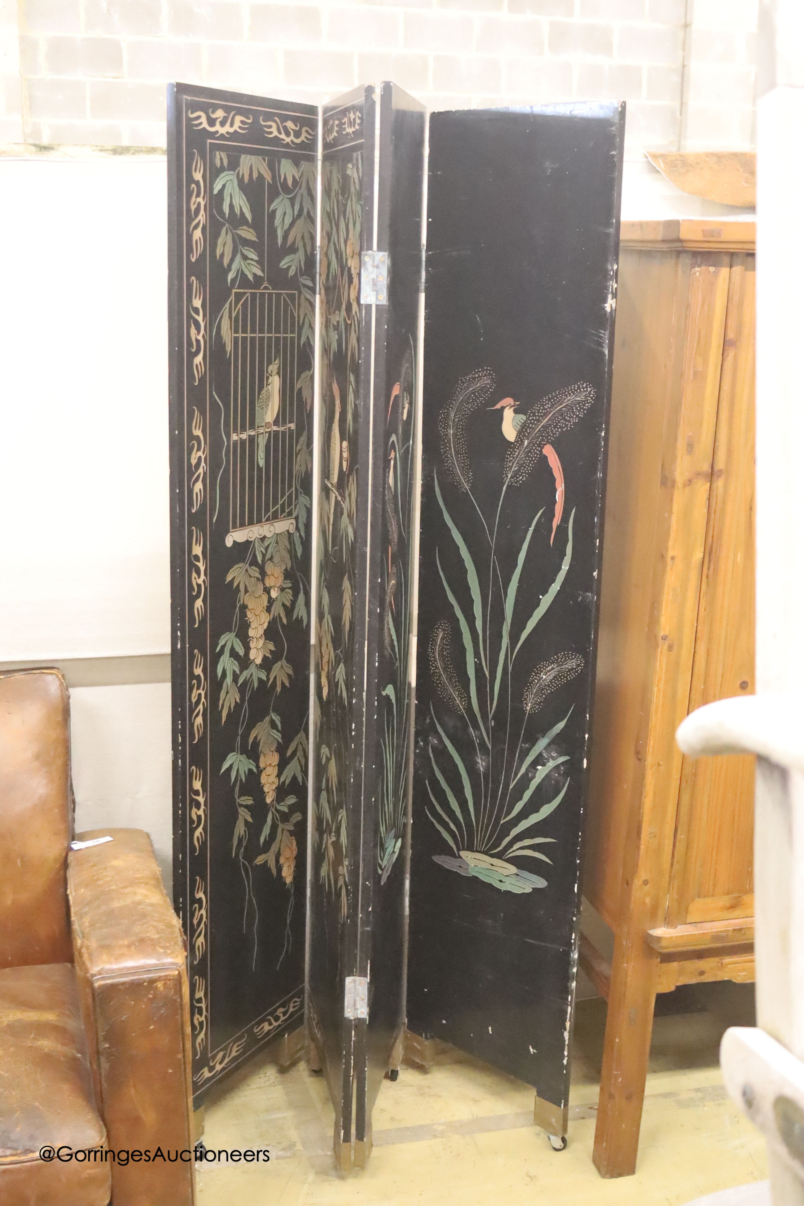 A Chinese ebonised four fold draught screen, painted each side with exotic birds and foliage, each panel width 40cm, height 187cm